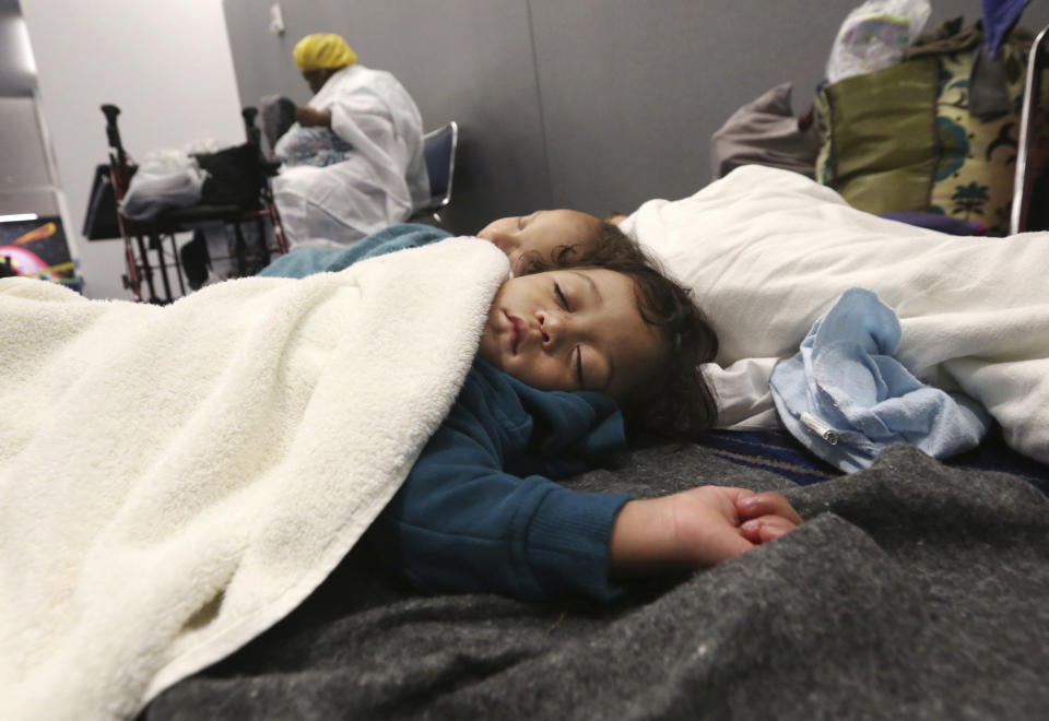 <p>Robert Salgado, 2, sleeps on the floor at the George R. Brown Convention Center that has been set up as a shelter for evacuees escaping the floodwaters from Tropical Storm Harvey in Houston, Texas, Tuesday, Aug. 29, 2017. (Photo: LM Otero/AP) </p>