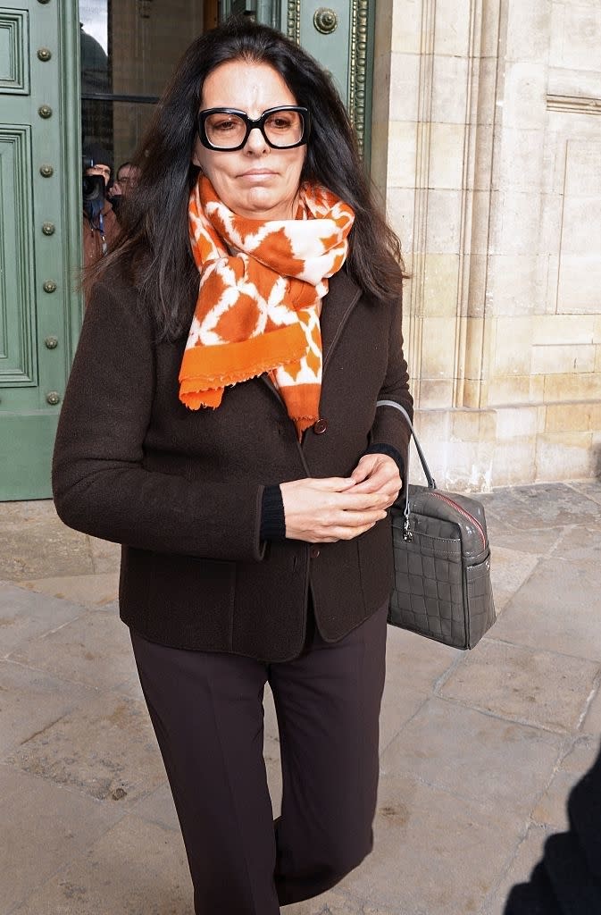 closeup of her walking out of a building