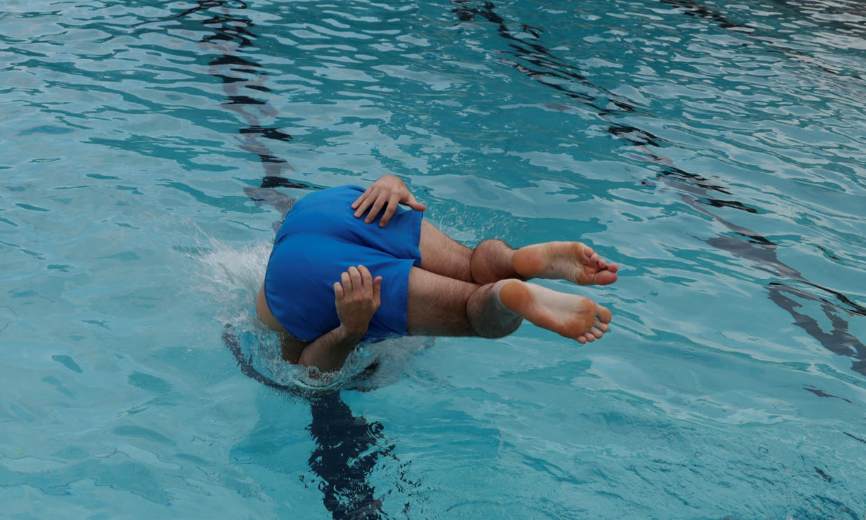 A man jumps in the public swimming pool of Schoenbrunner Bad in Vienna, as a heatwave hits the country, Austria June 27, 2019.  REUTERS/Leonhard Foeger