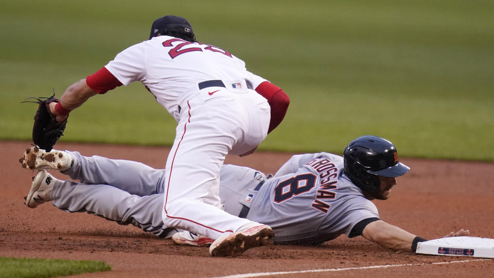 Detroit Tigers' Robbie Grossman (8) dives back safely to first as Boston Red Sox first baseman Bobby Dalbec catches the pick-off throw during the first inning of a baseball game at Fenway Park, Tuesday, May 4, 2021, in Boston. (AP Photo/Charles Krupa)