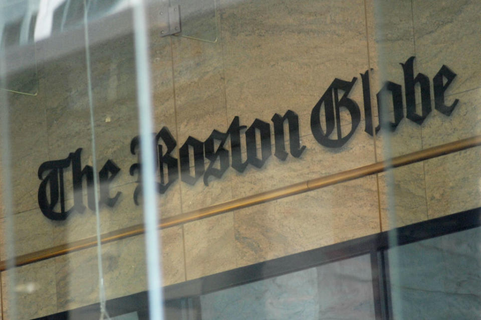 The image shows the logo of The Boston Globe displayed on a building