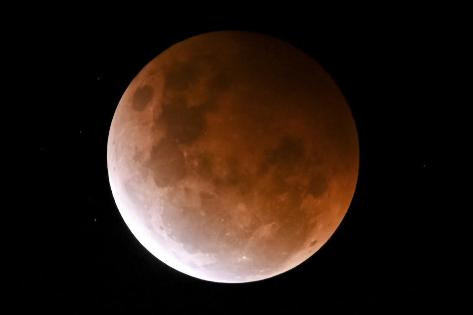 <p>SYDNEY, AUSTRALIA - MAY 26: The full moon, known as a âsuper flower blood moonâ, is seen during its maximum lunar eclipse phase, in Sydney, Australia, on May 26, 2021. The full moon on Wednesday will be the year's biggest super moon and feature the first total lunar eclipse in more than two years, known as a super blood moon. A super blood moon is when a total lunar eclipse (or âblood moonâ) happens at the same time as asuper blood moon, when the moon will be at perigee, or the closest point to Earth in its orbit, making it appear about 7% larger than normal and 15% brighter. The eclipse will be visible from Australia, New Zealand, the Pacific, South-East Asia and parts of North and South America at the same time. (Photo by Steven Saphore/Anadolu Agency via Getty Images)</p> 