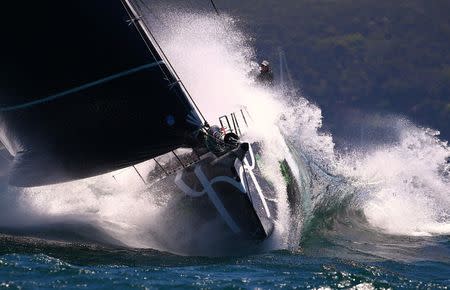 The crew aboard the yacht Perpetual Loyal react as they hit a wave sailing out of Sydney Harbour during the start of the annual Sydney to Hobart Yacht race, Australia's premiere bluewater classic, in Australia, December 26, 2016. REUTERS/David Gray