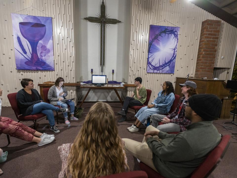 People in a circle in a church.