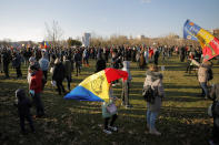 Anti-vaccination protesters rally outside the parliament building in Bucharest, Romania, Sunday, March 7, 2021. Some thousands of anti-vaccination protestors from across Romania converged outside the parliament building protesting against government pandemic control measures as authorities announced new restrictions amid a rise of COVID-19 infections. (AP Photo/Vadim Ghirda)