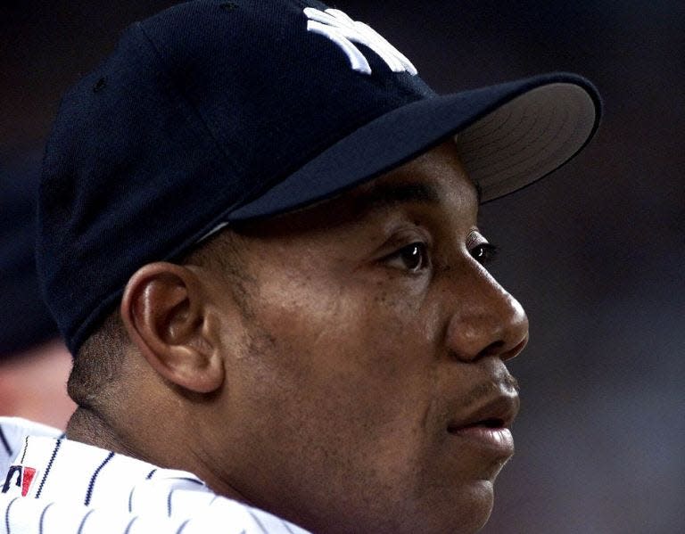 New York Yankees outfielder Gerald Williams watches the sixth inning of a game against the Tampa Bay Devil Rays at Yankee Stadium in New York, Friday, June 29, 2001.