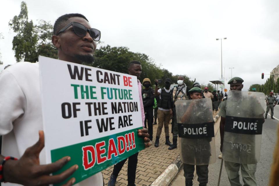 Protesters commemorate the one-year anniversary of #EndSARS, a protest movement against police brutality. <a href="https://www.gettyimages.com/detail/news-photo/man-displays-a-placard-during-a-protest-to-commemorate-one-news-photo/1235999623" rel="nofollow noopener" target="_blank" data-ylk="slk:Kola Sulaimon/AFP via Getty Images;elm:context_link;itc:0;sec:content-canvas" class="link ">Kola Sulaimon/AFP via Getty Images</a>