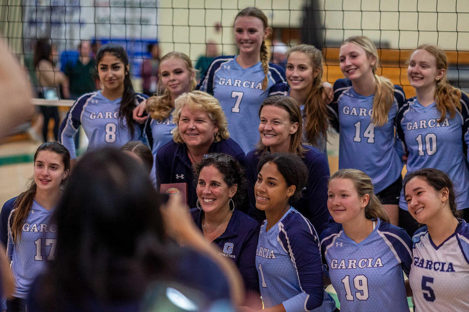 Coach Erica Green (center bottom) after the win as the Suncoast Community High School Chargers hosted the Dr. Joaquin Garc’a Bulldogs for the District 14-5A volleyball tournament championship at the school in Riviera Beach, Fla., on October 19, 2023. In their first year with a team, the Bulldogs won the match in five games.