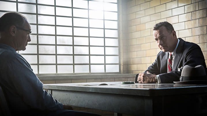 Two men talk at a table in Bridge of Spies.