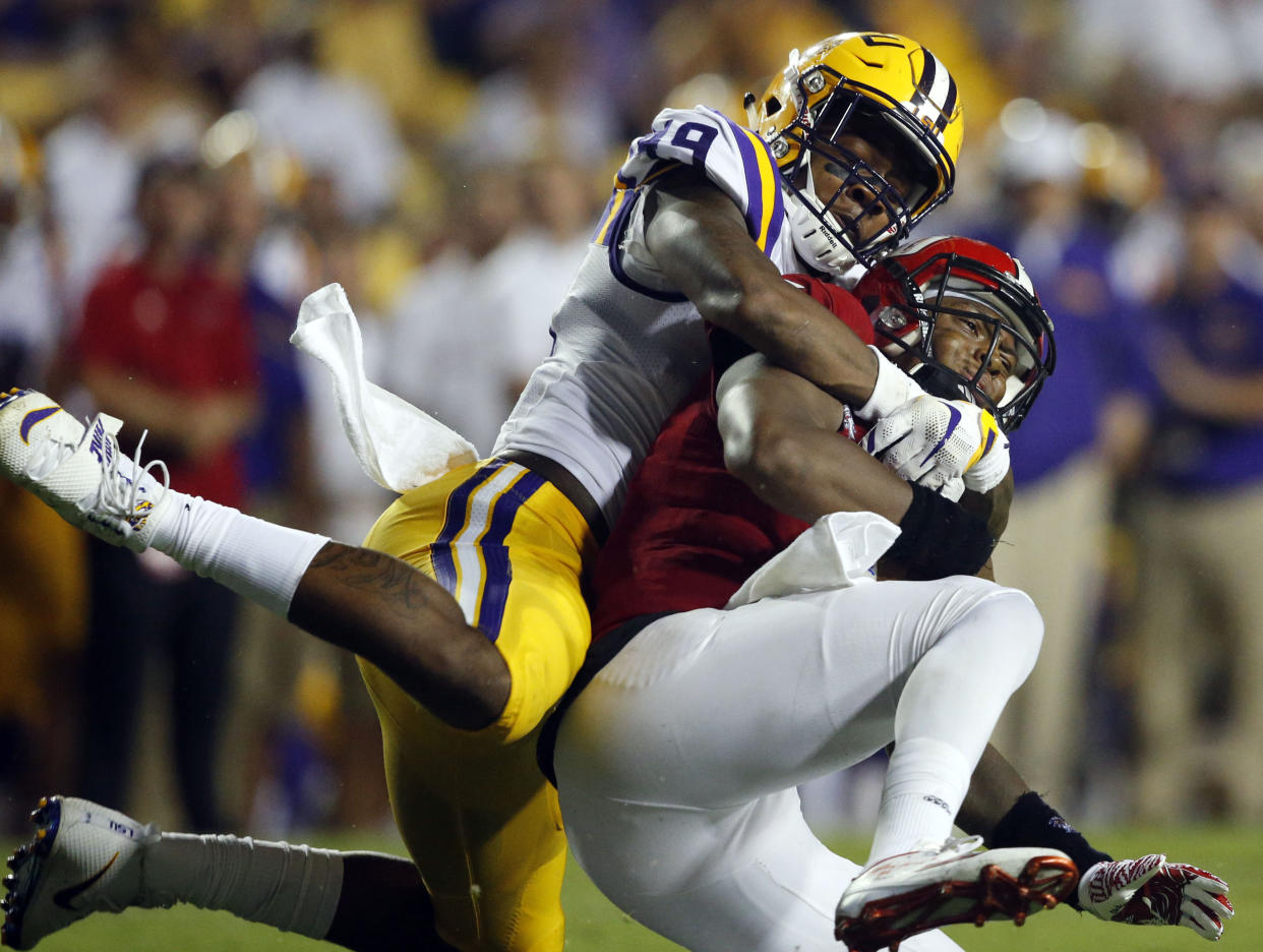 This Sept. 10, 2016, file photo shows Jacksonville State quarterback Eli Jenkins being sacked by LSU defensive end Arden Key (L). (AP Photo/Gerald Herbert, File)