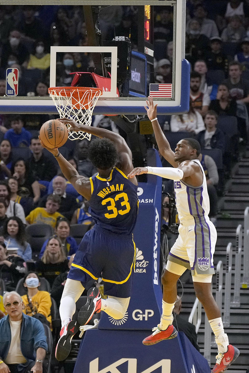 Golden State Warriors center James Wiseman (33) drives to the basket against Sacramento Kings guard De'Aaron Fox, right, during the first half of an NBA basketball game on Sunday, Oct. 23, 2022 in San Francisco. (AP Photo/ Tony Avelar)