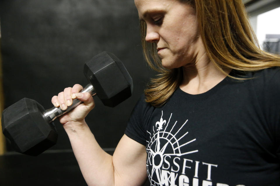 Melissa Breaux Bankston, a CrossFit athletic trainer at CrossFit Algiers in New Orleans, poses for a portrait at the gym Monday, Dec. 23, 2019. She participates in an intermittent fasting diet. (AP Photo/Gerald Herbert)