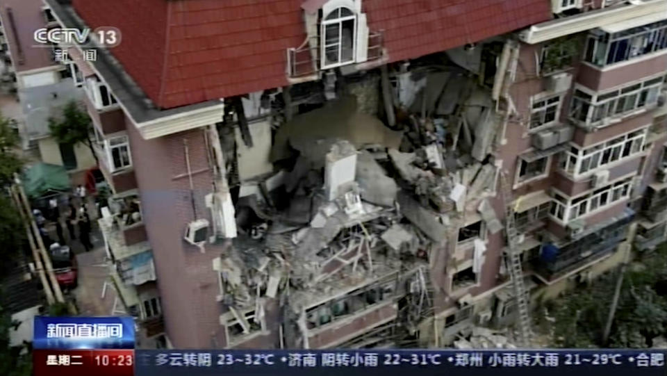 In this image taken from video footage run by China's CCTV, an aerial shot shows a partially collapsed building in the eastern Chinese port city of Tianjin, Tuesday, July 19, 2022. A gas explosion and the partial building collapse, left some people missing and others injured. (CCTV via AP)