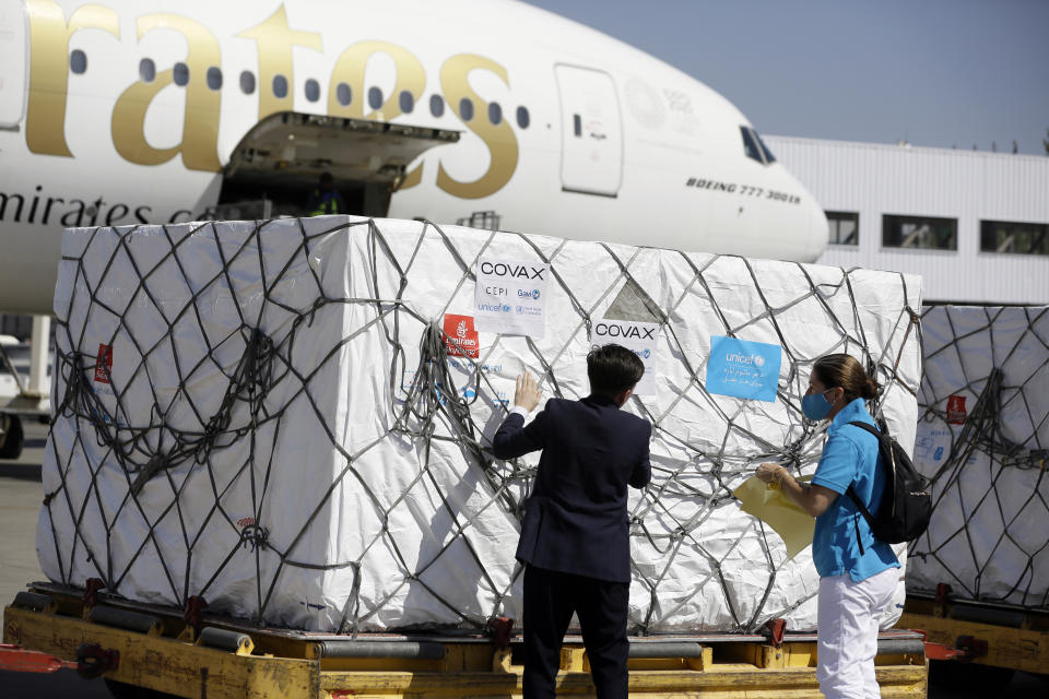 FILE - In this Friday, July 9, 2021 file photo, UNICEF workers check the first shipment of 1.4 million Johnson & Johnson COVID-19 vaccine doses donated by the United States, at the Hamid Karzai International Airport, in Kabul, Afghanistan. In late June, the international system for sharing coronavirus vaccines sent about 530,000 doses to Britain – more than double the amount sent that month to the entire continent of Africa. It was the latest example of how a system that was supposed to guarantee low and middle-income countries vaccines is failing, leaving them at the mercy of haphazard donations from rich countries.(AP Photo/Mariam Zuhaib, file )