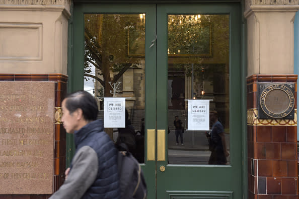 Signs sit on display on the doors of a pub informing customers of temporary closure during coronavirus lockdown in Melbourne.