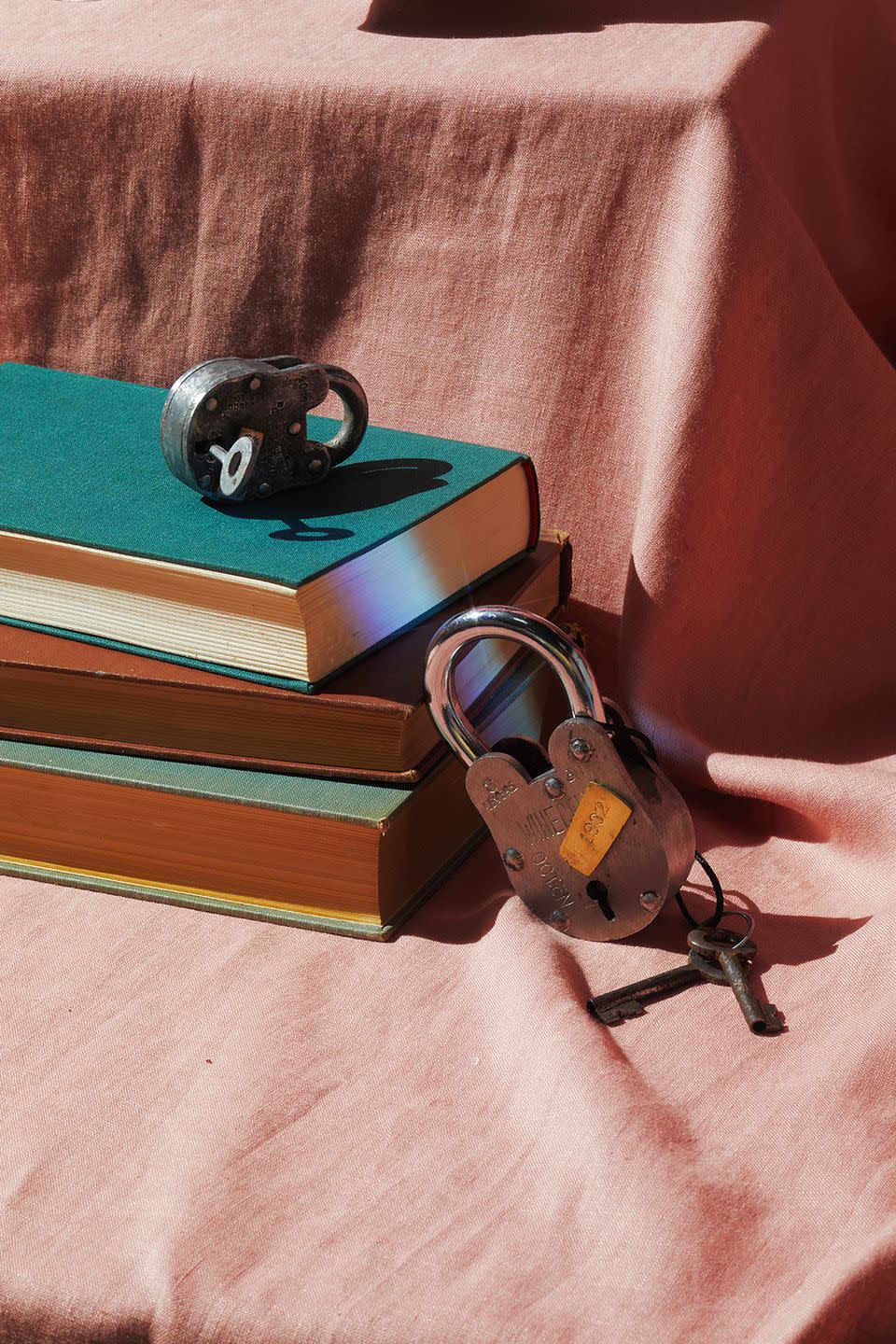 stack of books with lock and keys