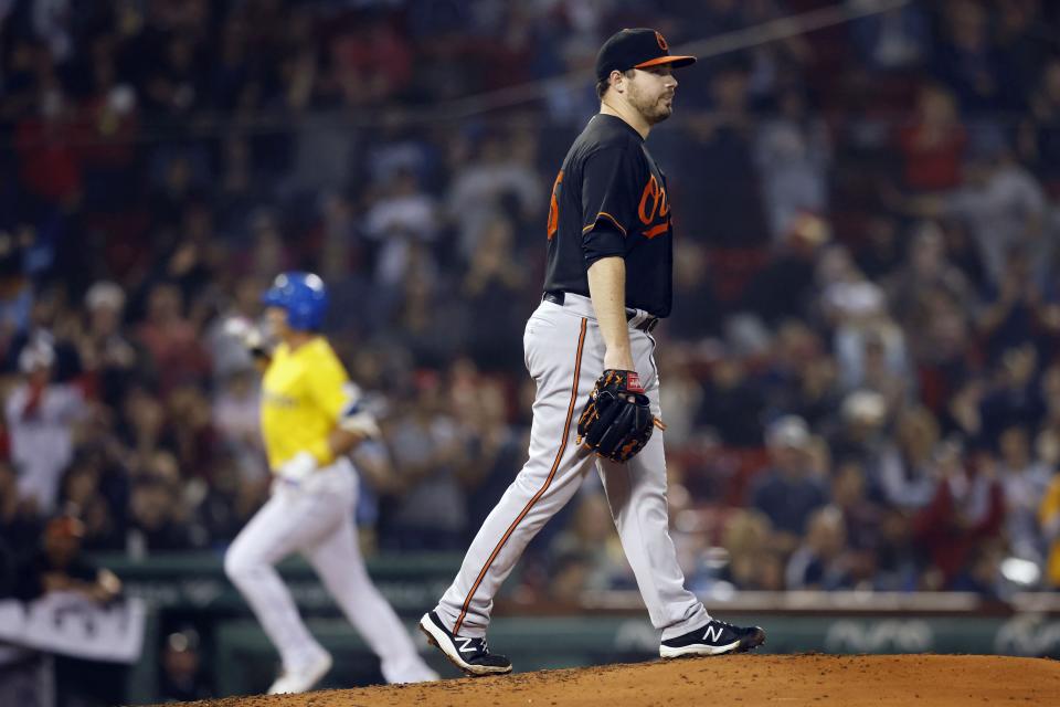 Baltimore Orioles' Keegan Akin walks on the mound after giving up a solo home run to Boston Red Sox's Bobby Dalbec, left, during the fourth inning of a baseball game Friday, Sept. 17, 2021, in Boston. (AP Photo/Michael Dwyer)