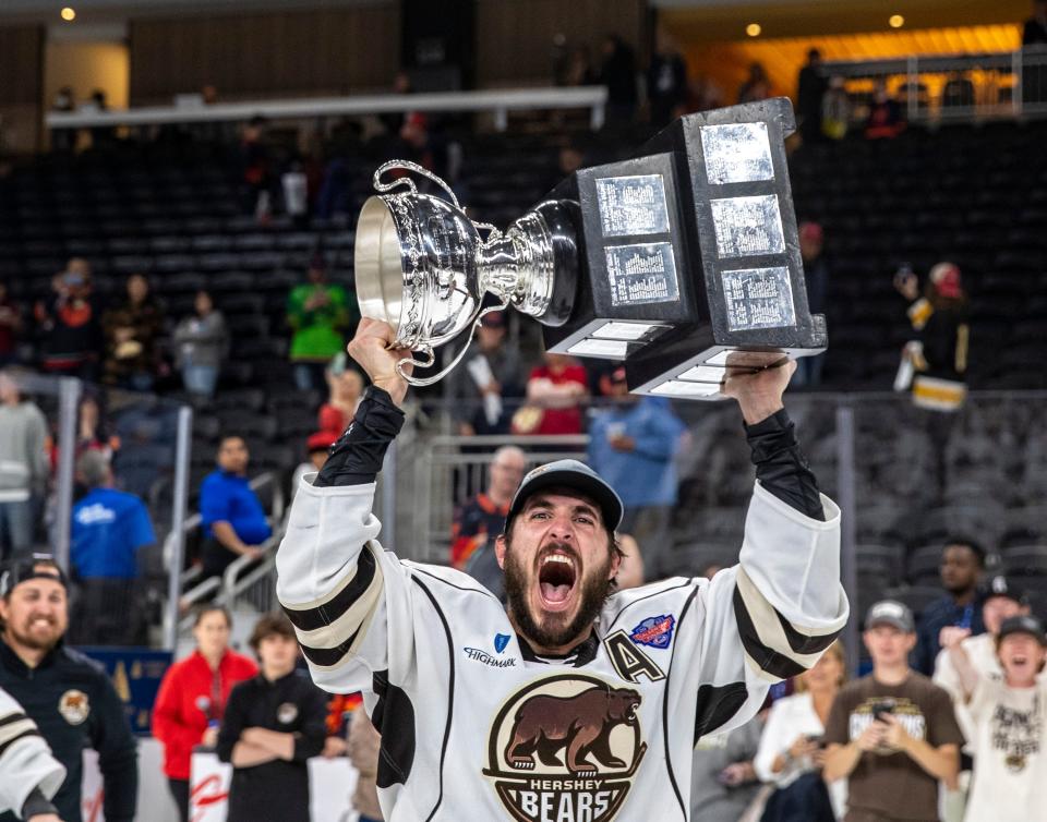 Hershey forward Mike Vecchione (19) holds up the Calder Cup trophy after scoring the winning goal in Game 7 of the Calder Cup Finals at Acrisure Arena in Palm Desert, Calif., Wednesday, June 21, 2023. 