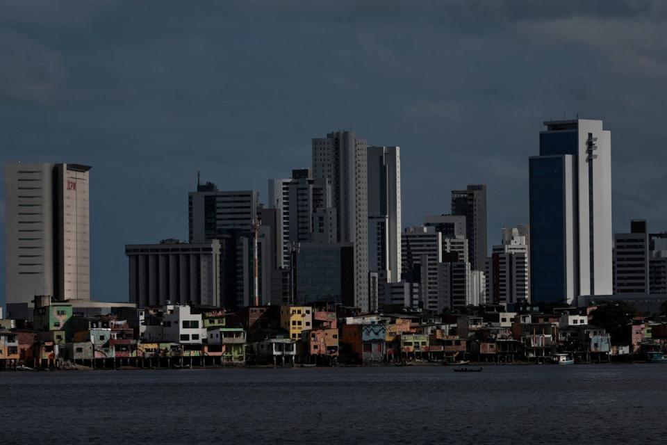 A view of the Brasilia Teimosa favela is seen beneath the residential buildings of the Boa Viagem neighbourhood in Recife (Reuters)