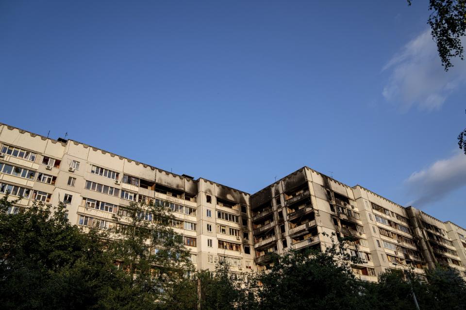 FILE - An apartment building damaged by an attack in Kharkiv, Ukraine, July 4, 2022. As Russia's invasion of Ukraine grinds into its fifth month, some residents close to the front lines remain in shattered and nearly abandoned neighborhoods. One such place is Kharkiv's neighborhood of Saltivka, once home to about half a million people. Only perhaps dozens live there now, in apartment blocks with no running water and little electricity. (AP Photo/Evgeniy Maloletka, File)