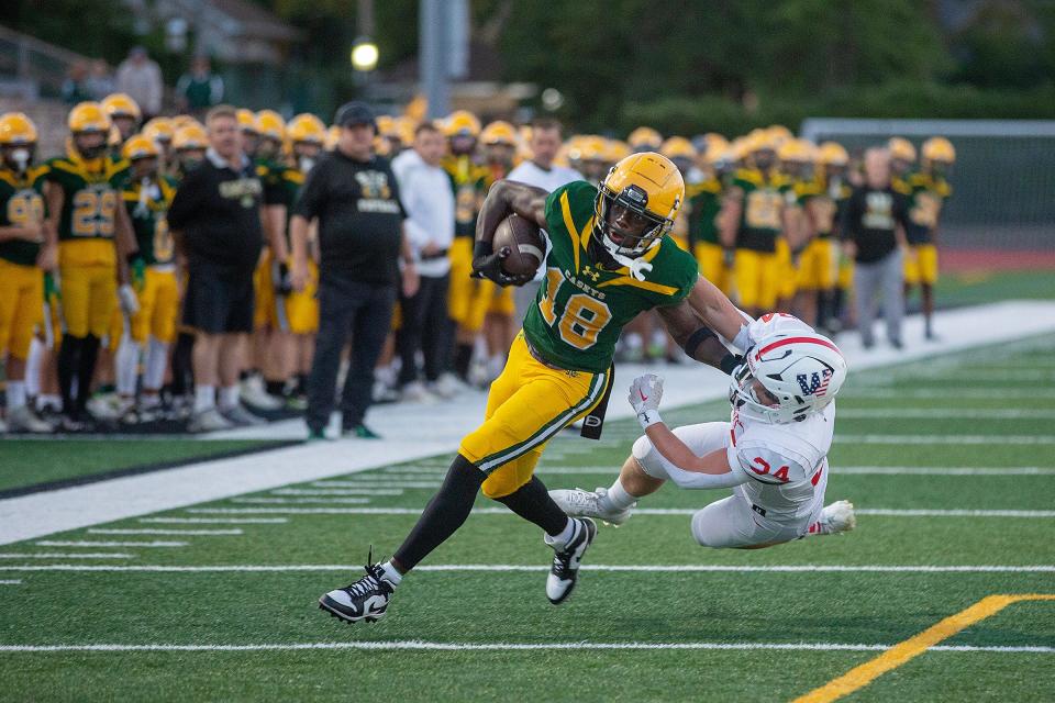 RBC's Emanuel Ross runs the ball around Wall's Jack Murphy for a 2 point conversion during the first half of the Wall Township Crimson Knights vs. Red Bank Catholic Caseys high school football game at Count Basie Park in Red Bank, NJ Friday, September 15, 2023.