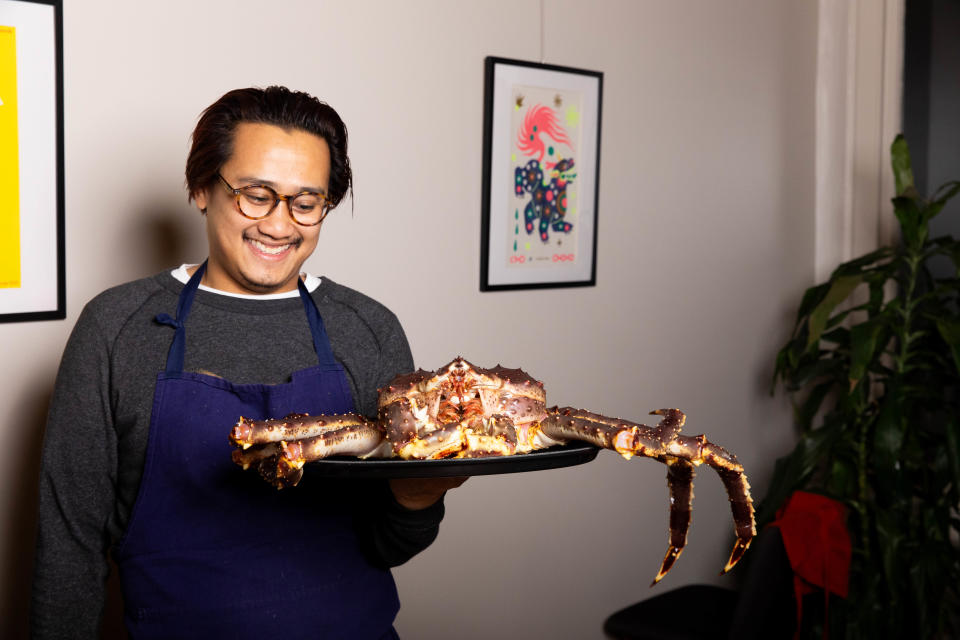 Chef Colby Rasavong of Bad Idea holds a Norwegian king crab.