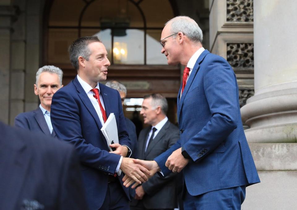 Northern Ireland First Minister Paul Givan (left) greets Ireland’s Minister for Foreign Affairs Simon Coveney at a centenary event in Belfast (Peter Morrison/PA) (PA Wire)