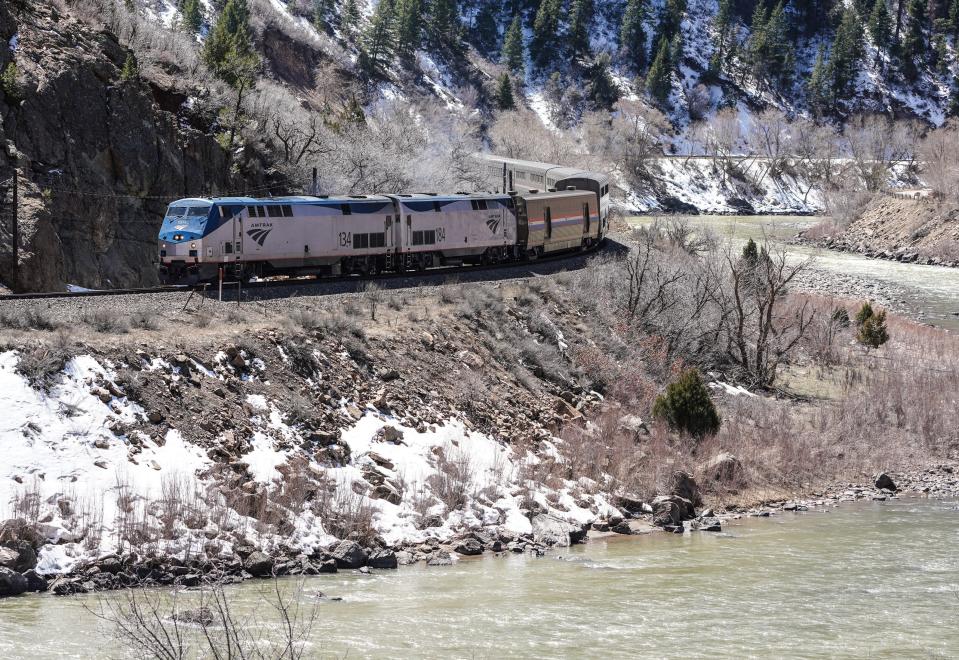 Amtrak's California Zephyr train climbs out of Glenwood Springs, Colorado, through Glenwood Canyon, alongside the Colorado River, on its way east to Denver.