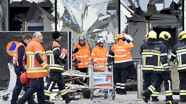 Workers collect debris at Brussels airport following the destruction. Photo: Reuters