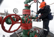 An employee turns a valve while inspecting a well head in the Yarakta Oil Field, owned by Irkutsk Oil Company (INK), in Irkutsk Region, Russia March 10, 2019. REUTERS/Vasily Fedosenko