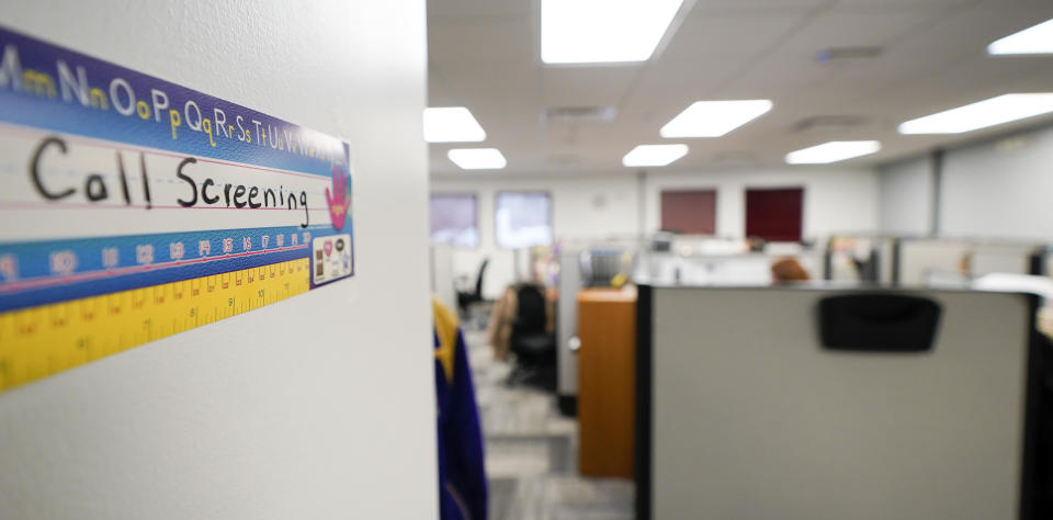 Workers field calls at an intake call screening center for the Allegheny County Children and Youth Services office in Penn Hills, Pa. on Thursday, Feb. 17, 2022. Incidents of potential neglect are reported to Allegheny County’s child protection hotline. The reports go through a screening process where the algorithm calculates the child’s potential risk and assigns it a score. Social workers then use their discretion to decide whether to investigate those concerns. (AP Photo/Keith Srakocic)