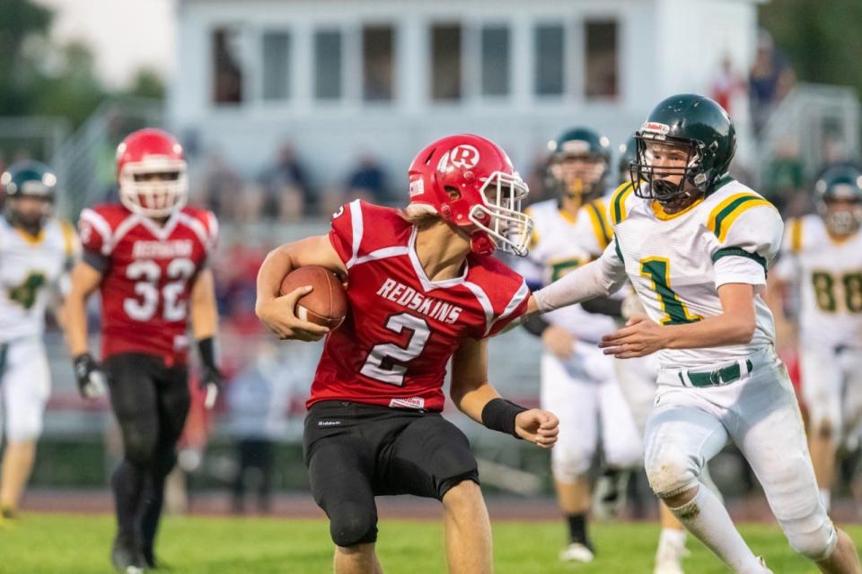 Canisteo-Greenwood quarterback Braidon Woodward avoids a hit against CG Finney in Canisteo. The Canisteo-Greenwood Board of Education voted Wednesday to drop its mascot and team name, the Redskins, as of June 30, 2023.