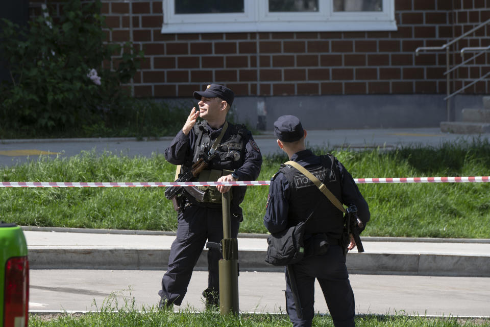 Police officers guard an area where a Ukrainian drone damaged an apartment building in Moscow, Russia, Tuesday, May 30, 2023. In Moscow, residents reported hearing explosions and Mayor Sergei Sobyanin later confirmed there had been a drone attack that he said caused "insignificant" damage. (AP Photo)