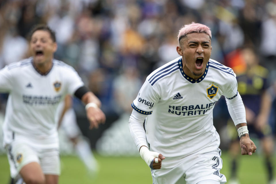 LA Galaxy defender Julian Araujo, right, reacts after scoring a goal, with forward Javier Hernandez following against the Nashville SC during the second half of an MLS playoff soccer match, in Carson, Calif., Saturday, Oct. 15, 2022. (AP Photo/Alex Gallardo)