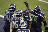 Seattle Seahawks tight end Jacob Hollister (86) celebrates with teammates after he caught a pass for a touchdown against the Los Angeles Rams during the second half of an NFL football game, Sunday, Dec. 27, 2020, in Seattle. (AP Photo/Elaine Thompson)