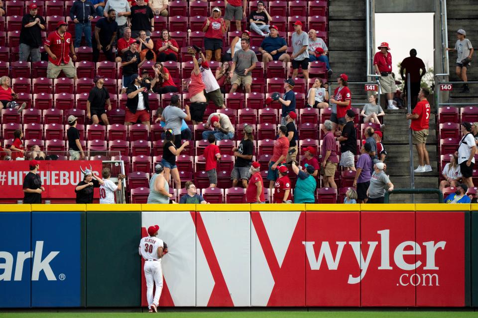 Cincinnati Reds right fielder Will Benson (30) looks on as a home run ball hit by Seattle Mariners shortstop J.P. Crawford (3) enters the stands in the fourth inning of the MLB baseball game between the Cincinnati Reds and the Seattle Mariners at Great American Ball Park in Cincinnati on Wednesday, Sept. 6, 2023.