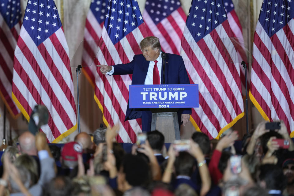 Former President Donald Trump points to supporters in the crowd after he announces his 2024 presidential campaign at Mar-a-Lago in Palm Beach, Fla.