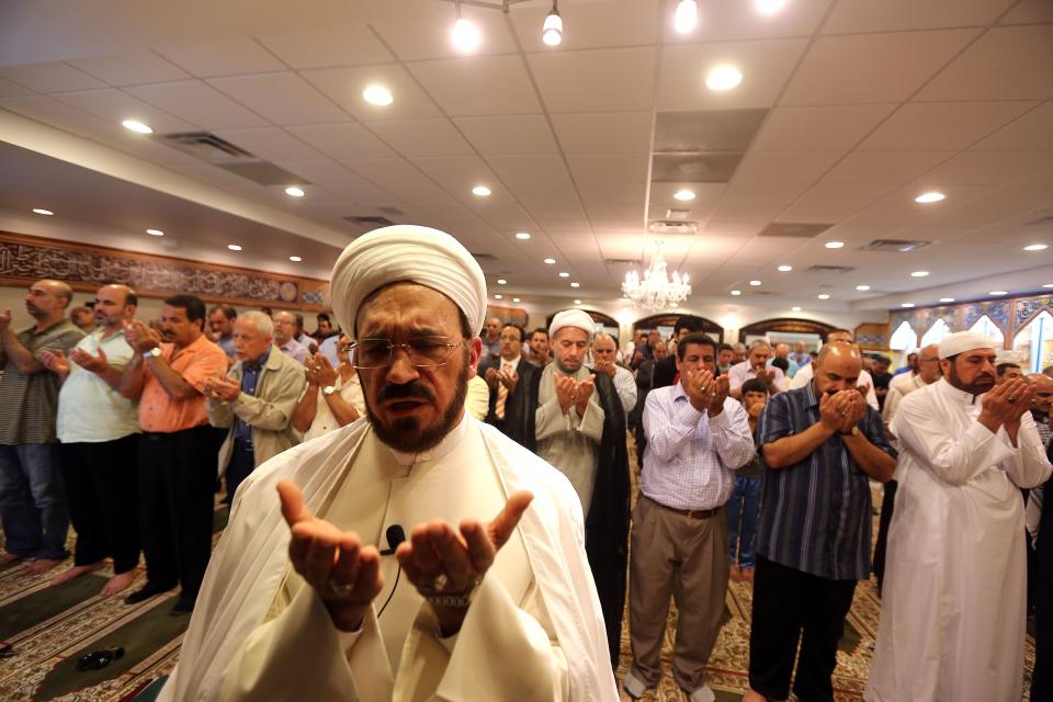 Imam Mohammad Ali Elahi leads his congregation in prayer before the start of Ramadan at the Islamic House of Wisdom in Dearborn Heights in 2013.