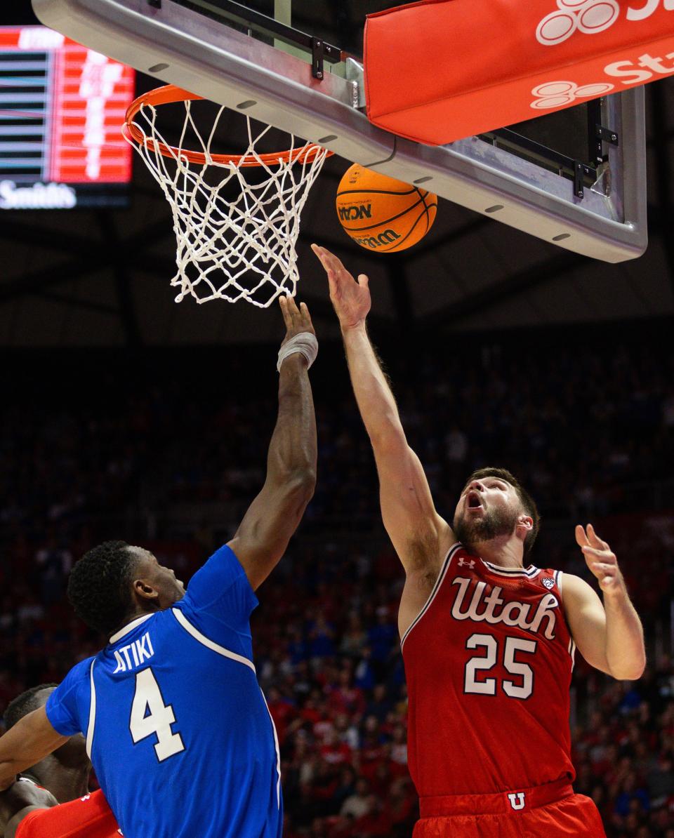 Utah Utes guard Rollie Worster (25) shoots the ball with Brigham Young Cougars forward Atiki Ally Atiki (4) on defense during a men’s basketball game at the Jon M. Huntsman Center in Salt Lake City on Saturday, Dec. 9, 2023. | Megan Nielsen, Deseret News