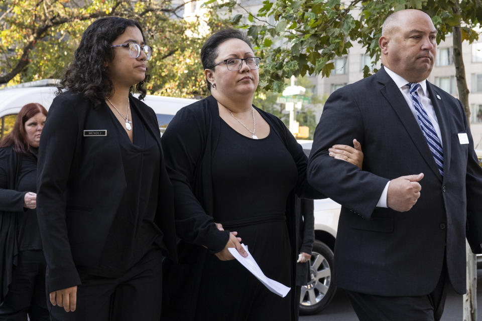Alex Mendez, center, arrives for the viewing of her late husband, officer Richard Mendez, alongside their daughter Mia Mendez, left, at the Cathedral Basilica of Saints Peter and Paul in Philadelphia, Tuesday, Oct. 24, 2023. Mendez was shot and killed, and a second officer was wounded when they confronted people breaking into a car at Philadelphia International Airport on Oct. 12, 2023, police said. (AP Photo/Joe Lamberti)