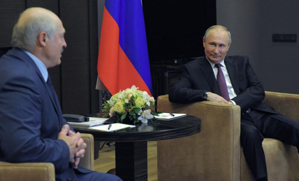 Russian President Vladimir Putin, right, smiles as he listens to Belarusian President Alexander Lukashenko during their meeting in the Black Sea resort of Sochi, Russia, Friday, May 28, 2021. (Mikhail Klimentyev, Sputnik, Kremlin Pool Photo via AP)