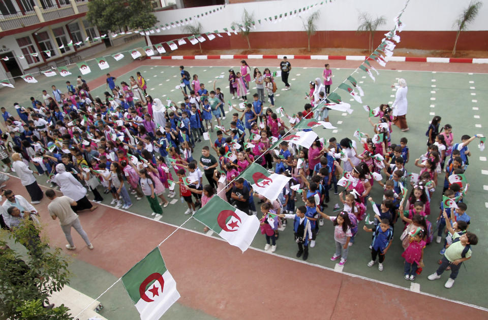 FILE - Schoolchildren wait in line in a school courtyard in in the Ben Omar district of Algiers, Algeria, on Sept.19, 2023. More than a year after Algeria launched a pilot program to teach English in elementary schools, the country is hailing it as a success and expanding it in a move that reflects a widening linguistic shift underway in former French colonies throughout Africa. (AP Photo, File)