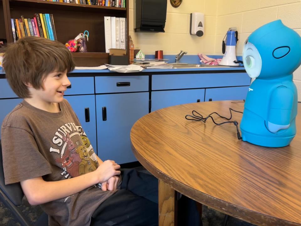 Wolverine third grader William Trugillo practices using the Moxie robot the district is introducing.