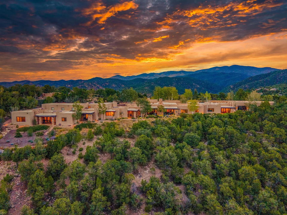 Exterior view of 1432 Old Sunset Trail, a sprawling adobe mansion in Santa Fe, New Mexico on the market for $8.5 million.