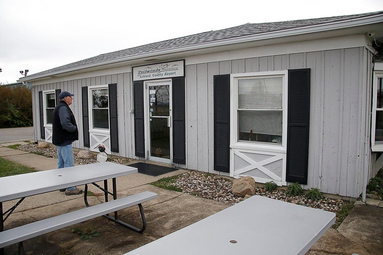 Denny Baum checks for damage to the siding on the terminal at the Ashland County Airport on Wednesday, Nov. 17, 2021. The building was built in 1970. TOM E. PUSKAR/TIMES-GAZETTE.COM