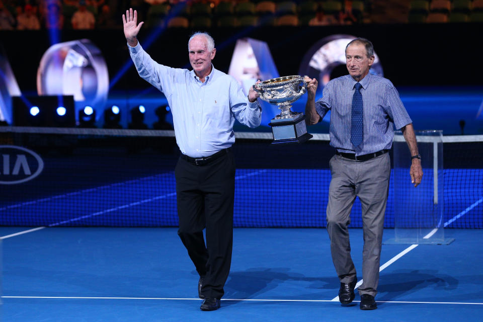 Former champions Bill Bowrey, left and Ashley Cooper, right, present the Norman Brookes Challenge Cup on the 50th and 60th anniversaries, respectively, of their Australian Open wins on Day 14 of the 2018 Australian Open. 