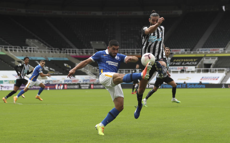 Brighton's Neal Maupay, left, duels for the ball with Newcastle's Andy Carroll during the English Premier League soccer match between Newcastle United and Brighton at St. James' Park in Newcastle, England, Sunday, Sept. 20, 2020. (Lee Smith/Pool via AP)