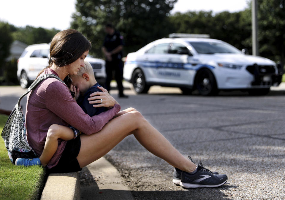 Carly McWatters holds her son at Collierville Town Hall on Friday, Sept. 24, 2021, in Collierville, Tenn., to pay their respects to the victims of the Kroger shooting the day before. (Patrick Lantrip/Daily Memphian via AP)