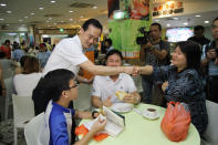 People's Action Party candidate Koh Poh Koon greets residents on a walkabout on Sunday, 13 January. (Yahoo! photo)