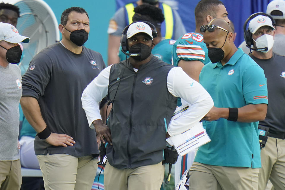 Miami Dolphins head coach Brian Flores, center, look up during the second half of an NFL football game against the New England Patriots, Sunday, Dec. 20, 2020, in Miami Gardens, Fla. (AP Photo/Chris O'Meara)